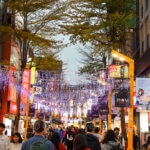 A one-day travel guide to Ximending featured a brightly lit pedestrian street lined with colorful shops and restaurants.