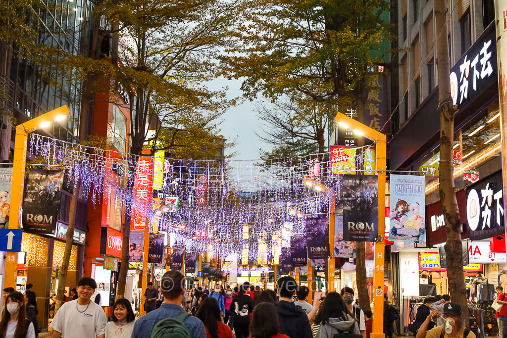 A one-day travel guide to Ximending featured a brightly lit pedestrian street lined with colorful shops and restaurants.