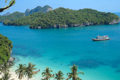 Modern Travel Traditions in Thailand features a boat sailing on turquoise waters under blue skies.