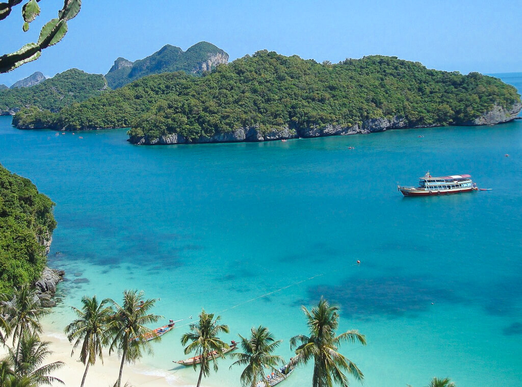 Modern Travel Traditions in Thailand features a boat sailing on turquoise waters under blue skies.