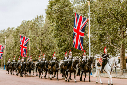The Royal Route: Exploring London’s Regal Legacy features an army of horsemen marching with British flags.