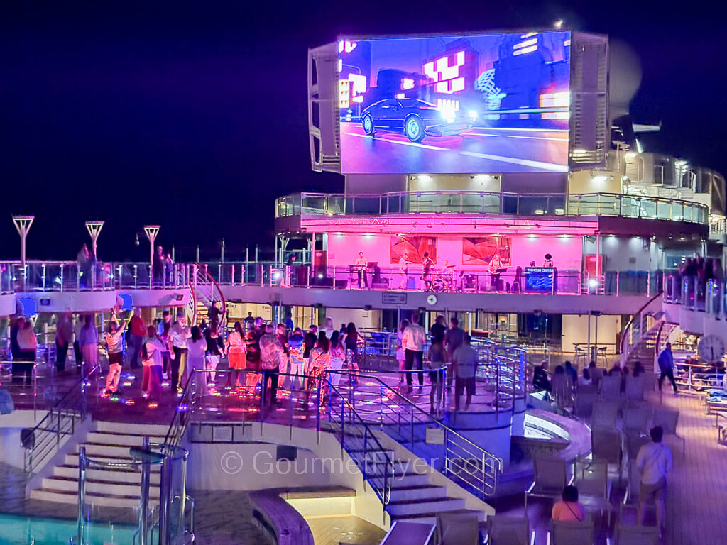 Princess Mexican Riviera cruise daily activities patters feature a deck party scene with a live band and colorful lights.