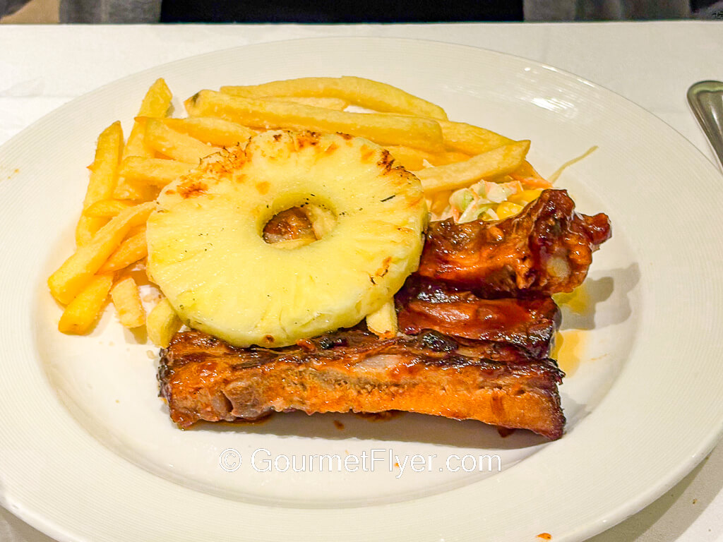 Pork ribs are served with French fries.