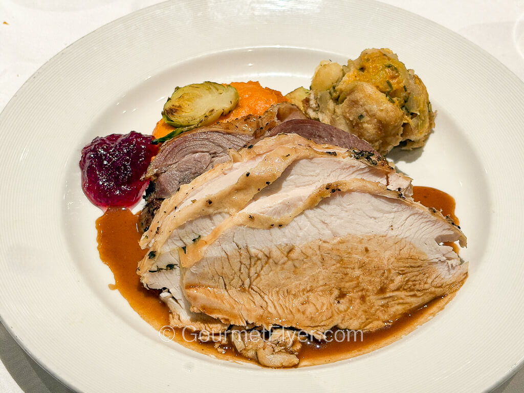 A turkey dinner paired with cranberry sauce and stuffing.