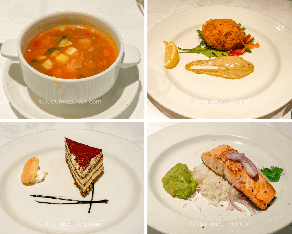 A review of Princess Alaska cruise dinner menus and food features a soup, crab cake app, a plate of salmon, and a slice of cake for dessert.