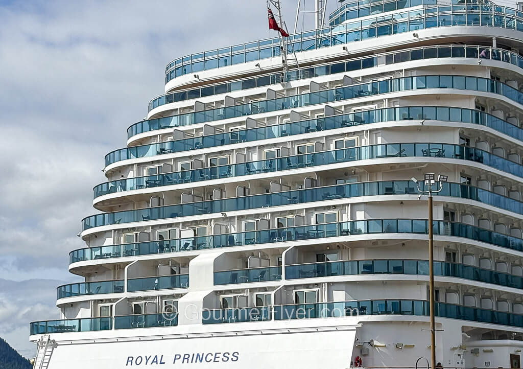 The aft of a cruise ship labeled Royal Princess has 7 decks of balcony cabins.