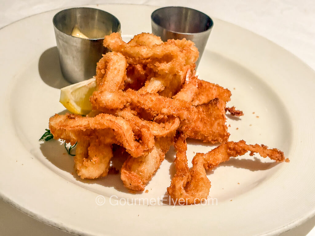 Strands of fried seafood have a golden-brown breaded crust.