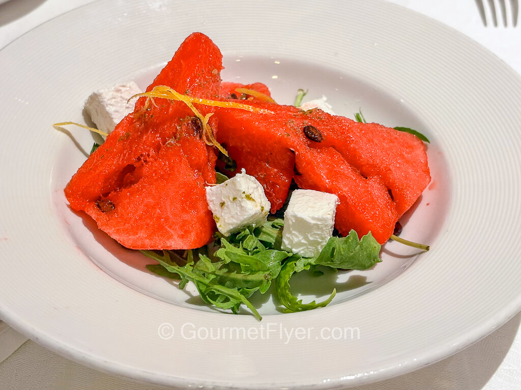Wedges of watermelon are paired with cubed feta cheese.